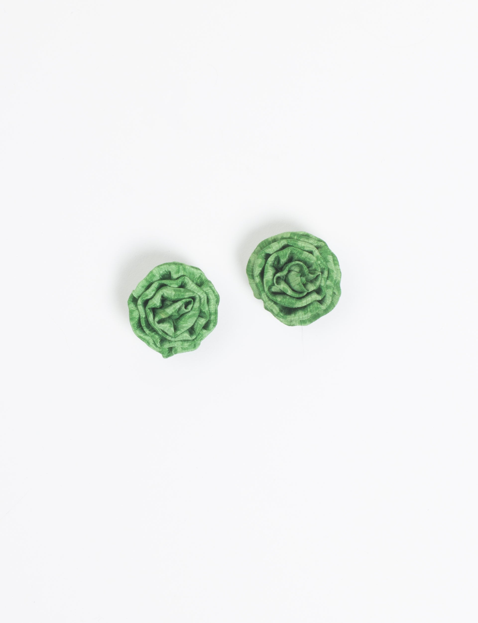 Pair of green fabric ruffle earrings shaped like roses, shown flat on a white background