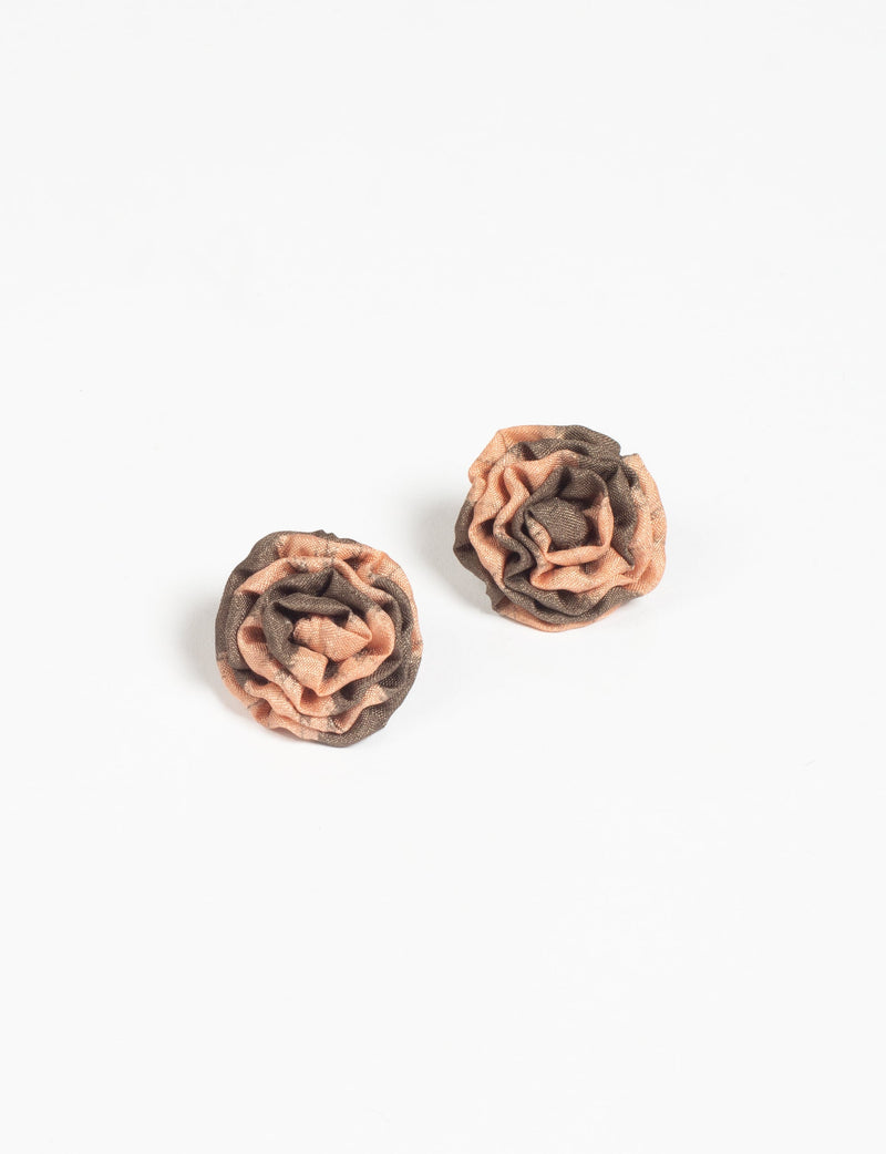 Pair of beige and brown abstract ruffle fabric earrings with a floral shape, shown on a white background