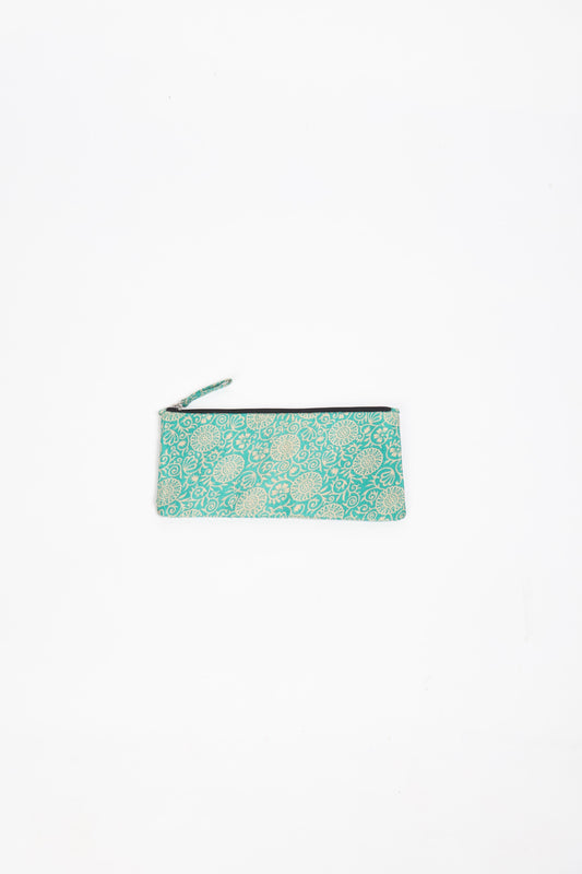 Eco-conscious quilted pencil pouch with waterproof lining made from upcycled garments, reflecting the values of circular fashion, carbon neutral fashion, and repurposed clothing. A perfect example of green fashion and sustainable women's clothing.