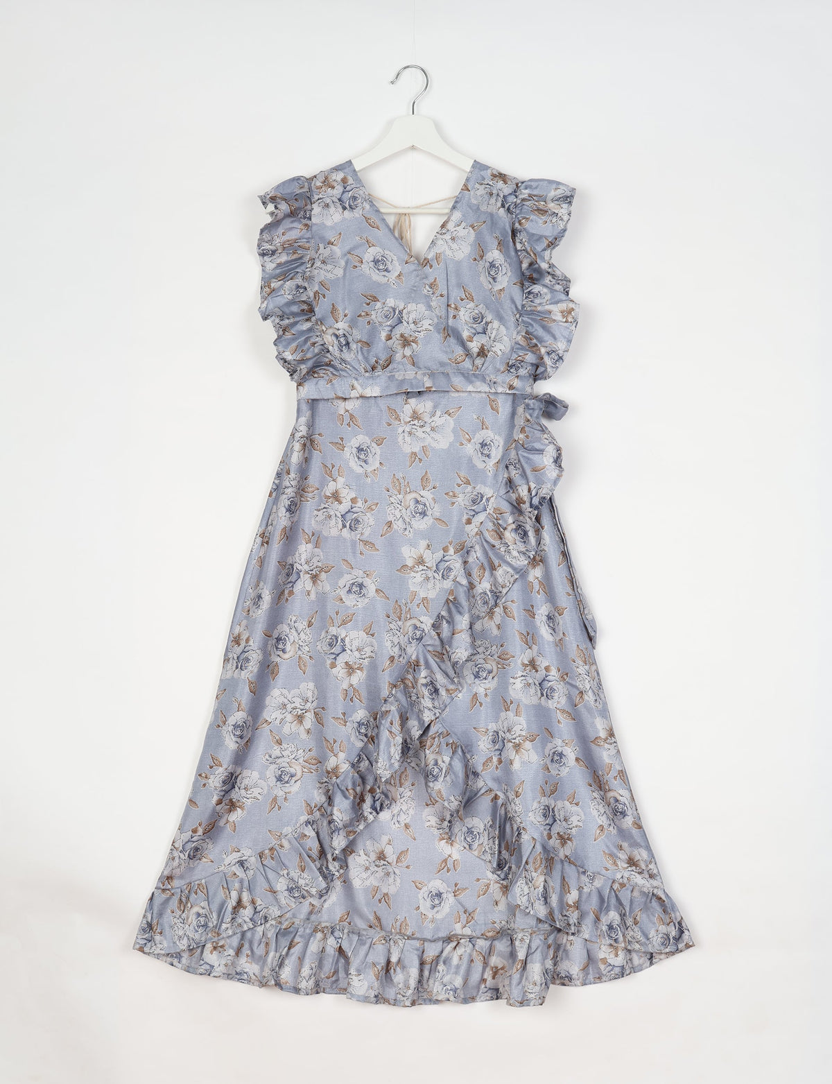 Grey floral frill skirt set with V-neck, ruffled sleeves, and wrap-style skirt hanging on white hanger against white background