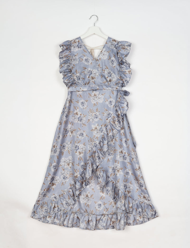 Grey floral frill skirt set with V-neck, ruffled sleeves, and wrap-style skirt hanging on white hanger against white background