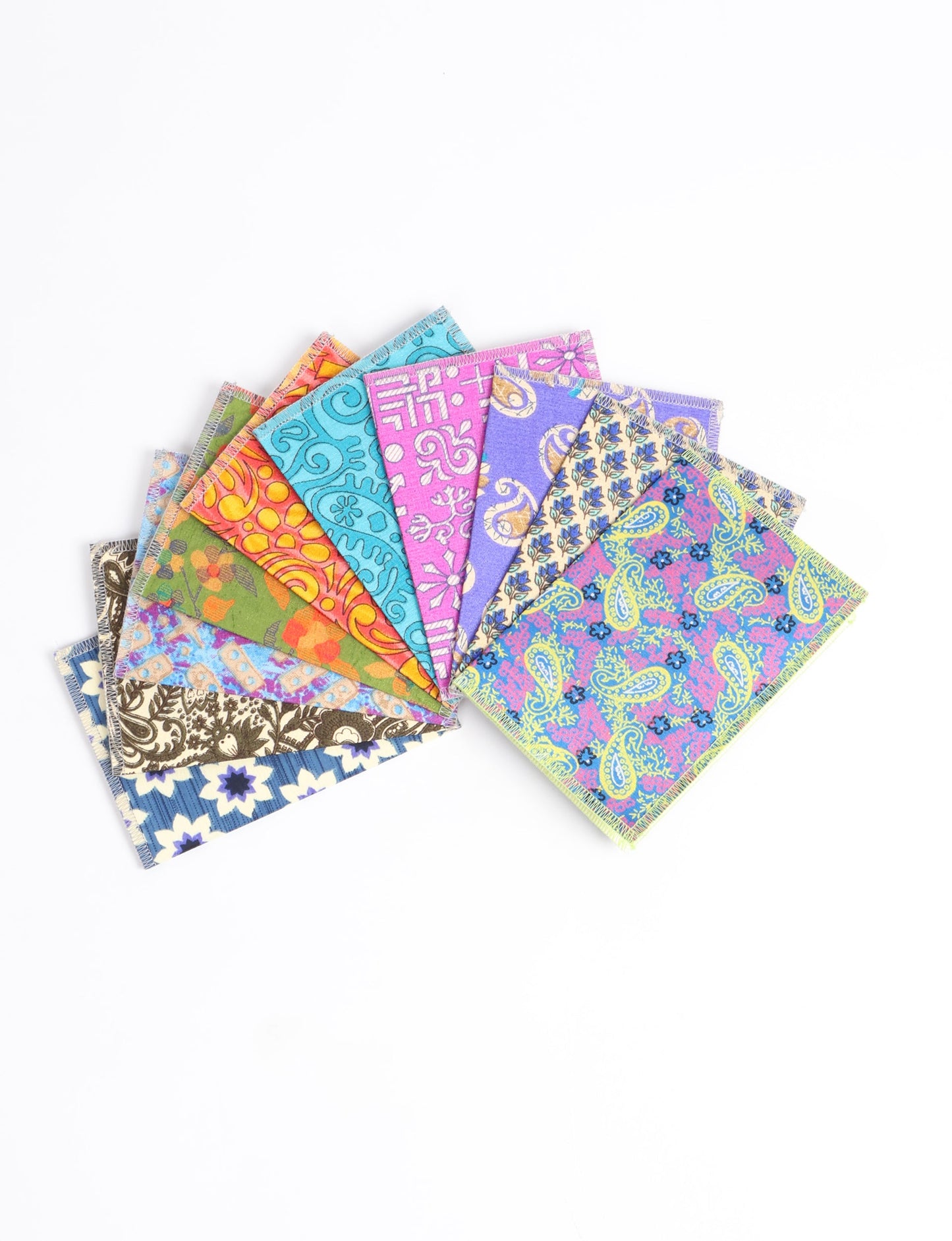 Sustainably crafted FOLDED POSTCARD SET, 10 assorted pieces made with 100% recycled paper and printed sari fabric sourced from Mumbai markets. Eco-friendly with contrast overlock edging. Envelopes included for eco-conscious gratitude and cheerful messages to loved ones.