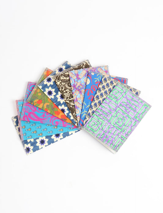 Sustainably crafted FOLDED POSTCARD SET, 10 assorted pieces made with 100% recycled paper and printed sari fabric sourced from Mumbai markets. Eco-friendly with contrast overlock edging. Envelopes included for eco-conscious gratitude and cheerful messages to loved ones.