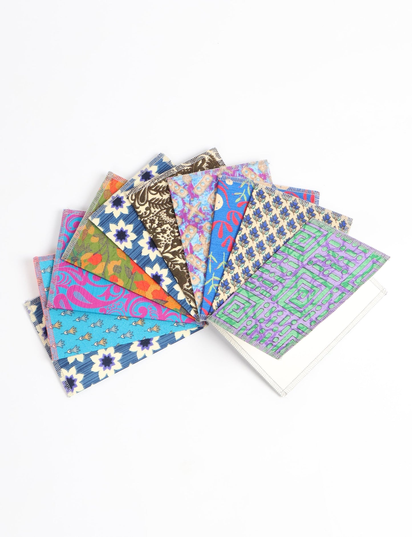 Sustainably crafted FOLDED POSTCARD SET, 10 assorted pieces made with 100% recycled paper and printed sari fabric sourced from Mumbai markets. Eco-friendly with contrast overlock edging. Envelopes included for eco-conscious gratitude and cheerful messages to loved ones.