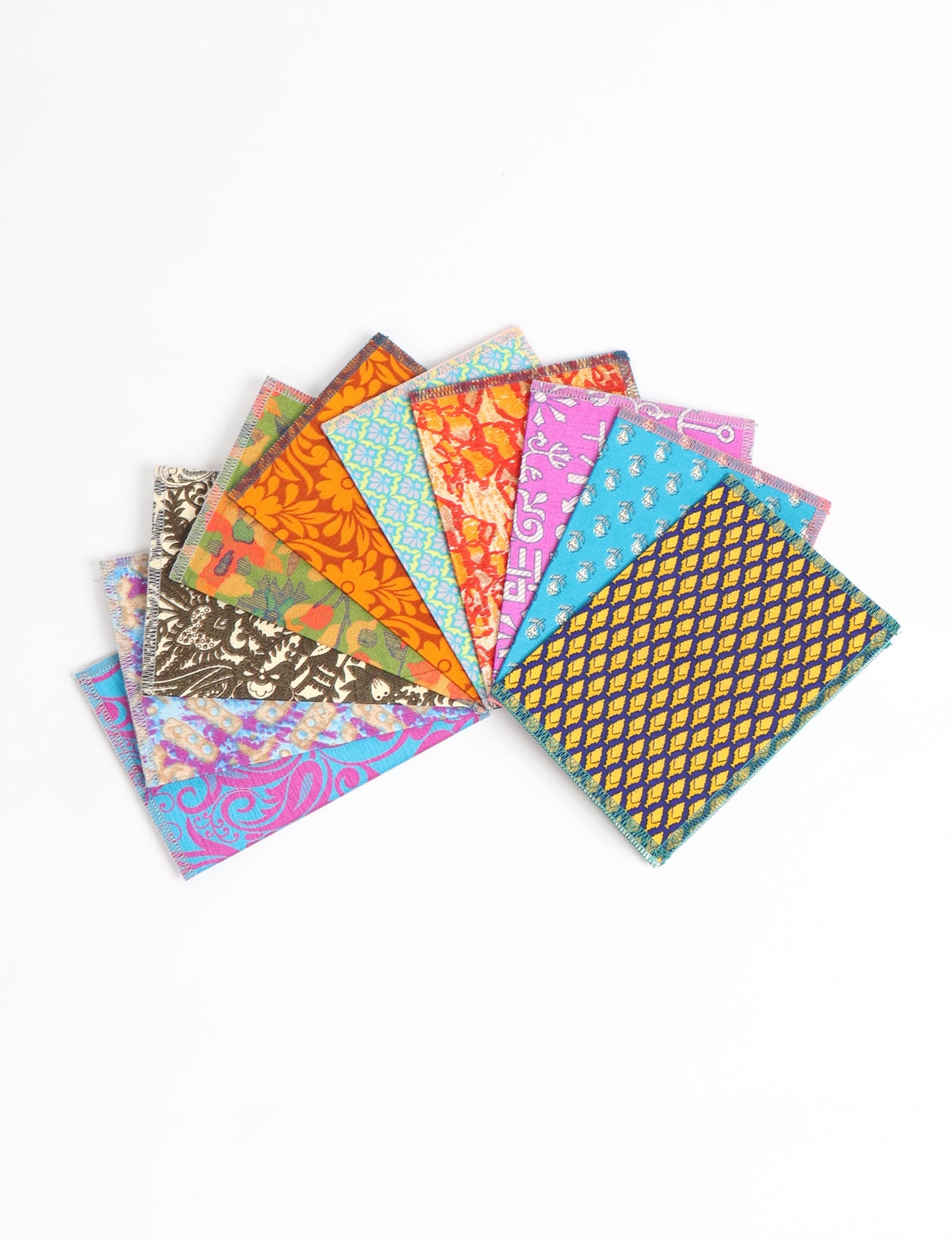 Sustainably crafted FOLDED POSTCARD SET, 10 assorted pieces made with 100% recycled paper and printed sari fabric sourced from Mumbai markets. Eco-friendly with contrast overlock edging. Envelopes included for eco-conscious gratitude and cheerful messages to loved ones.