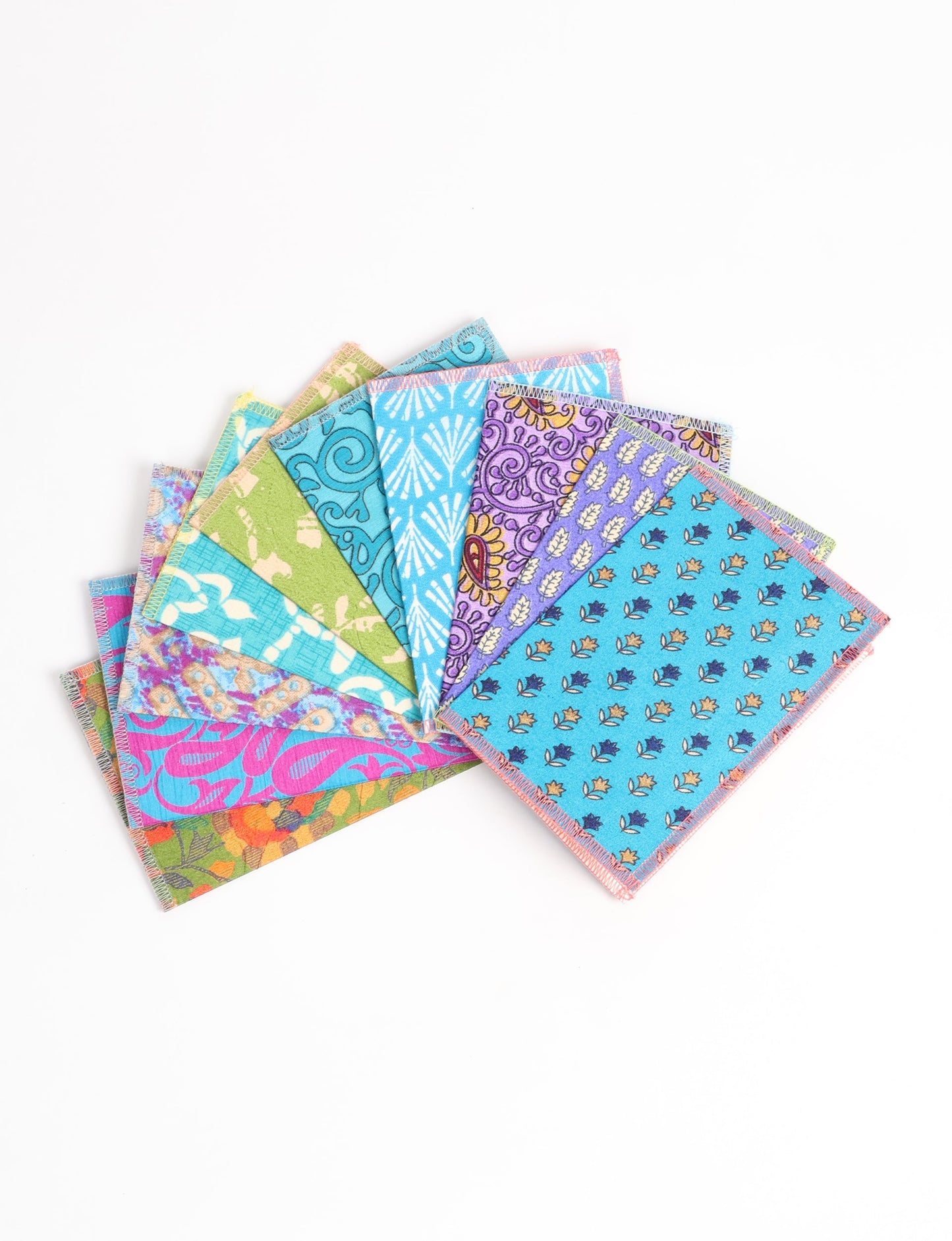 Sustainably crafted FOLDED POSTCARD SET, 10 assorted pieces made with 100% recycled paper and printed sari fabric sourced from Mumbai markets. Eco-friendly with contrast overlock edging. Envelopes included for eco-conscious gratitude and cheerful messages to loved ones.