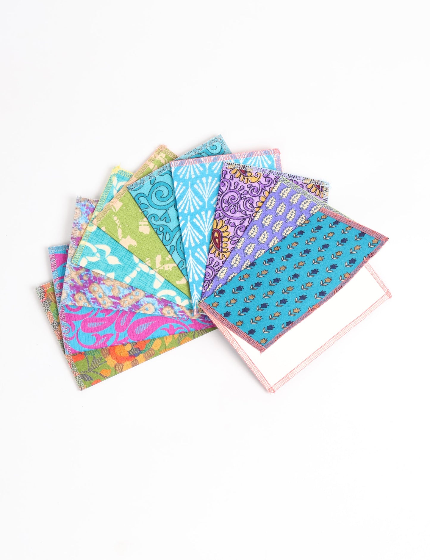 Sustainably crafted FOLDED POSTCARD SET, 10 assorted pieces made with 100% recycled paper and printed sari fabric sourced from Mumbai markets. Eco-friendly with contrast overlock edging. Envelopes included for eco-conscious gratitude and cheerful messages to loved ones.