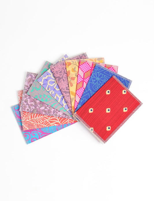 Sustainably crafted FOLDED POSTCARD SET, 10 assorted pieces made with 100% recycled paper and printed sari fabric sourced from Mumbai markets. Eco-friendly with contrast overlock edging. Envelopes included for eco-conscious gratitude and cheerful messages to loved ones.