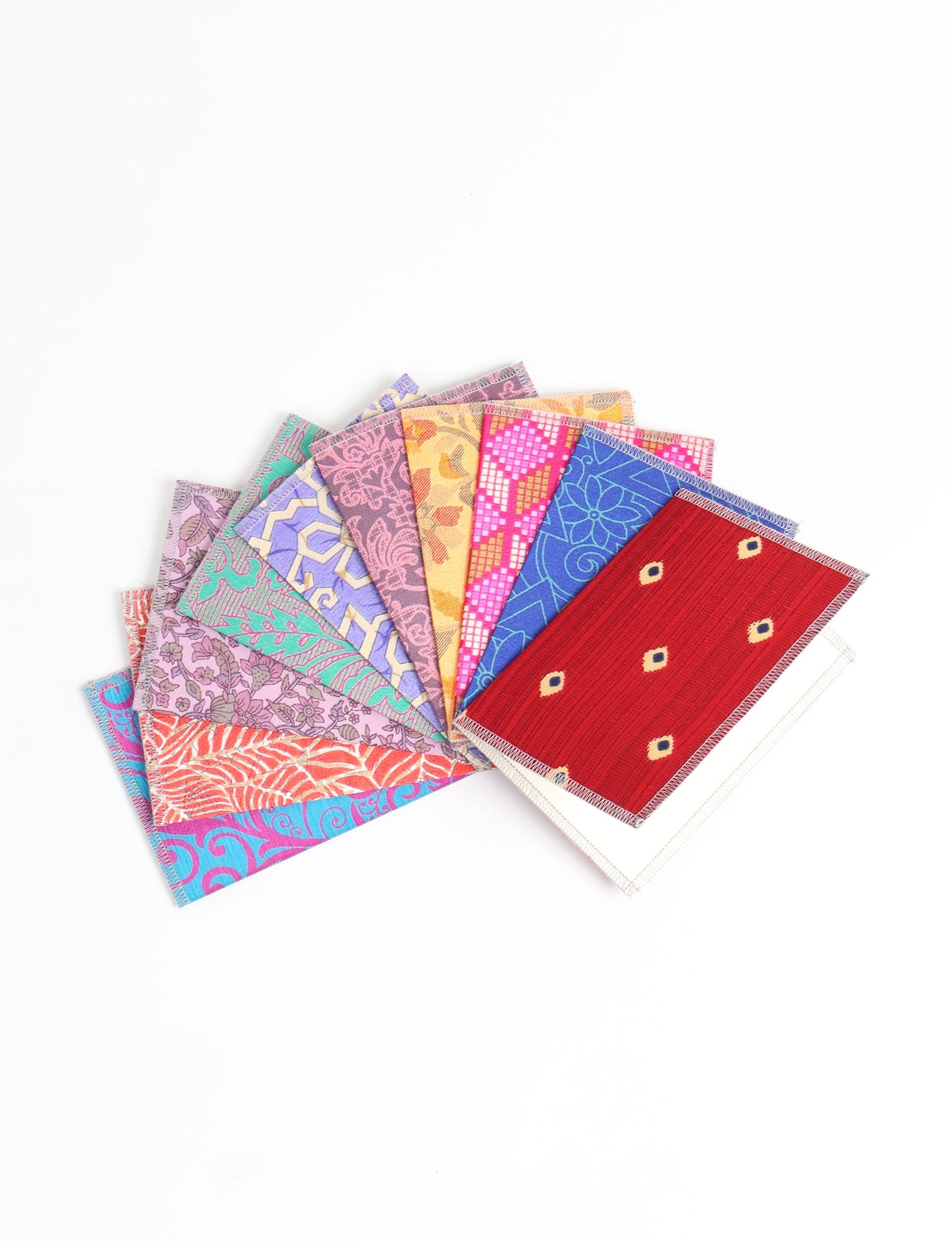 Sustainably crafted FOLDED POSTCARD SET, 10 assorted pieces made with 100% recycled paper and printed sari fabric sourced from Mumbai markets. Eco-friendly with contrast overlock edging. Envelopes included for eco-conscious gratitude and cheerful messages to loved ones.