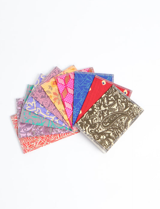Sustainably crafted FOLDED POSTCARD SET, 10 assorted pieces made with 100% recycled paper and printed sari fabric sourced from Mumbai markets. Eco-friendly with contrast overlock edging. Envelopes included for eco-conscious gratitude and cheerful messages to loved ones.