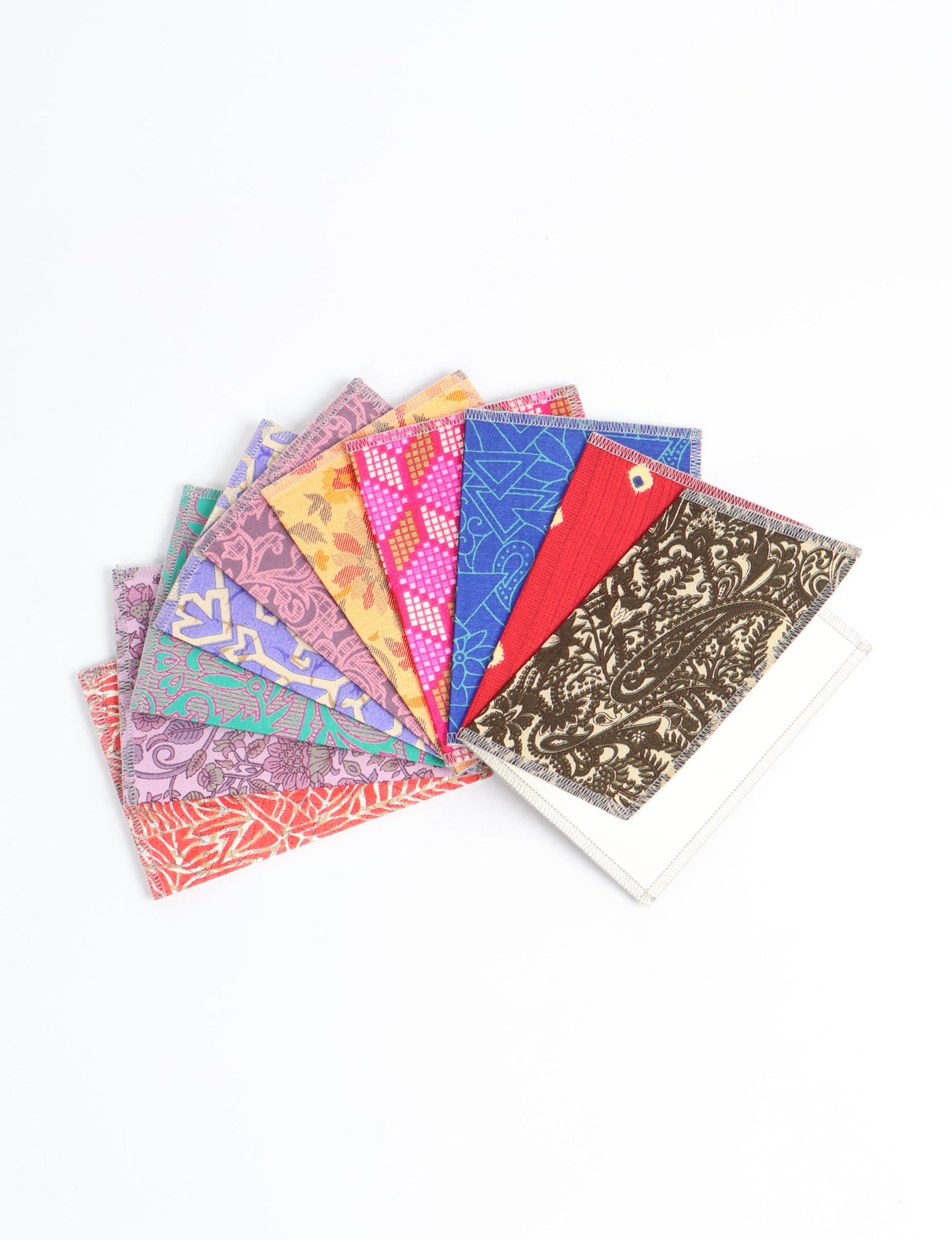 Sustainably crafted FOLDED POSTCARD SET, 10 assorted pieces made with 100% recycled paper and printed sari fabric sourced from Mumbai markets. Eco-friendly with contrast overlock edging. Envelopes included for eco-conscious gratitude and cheerful messages to loved ones.