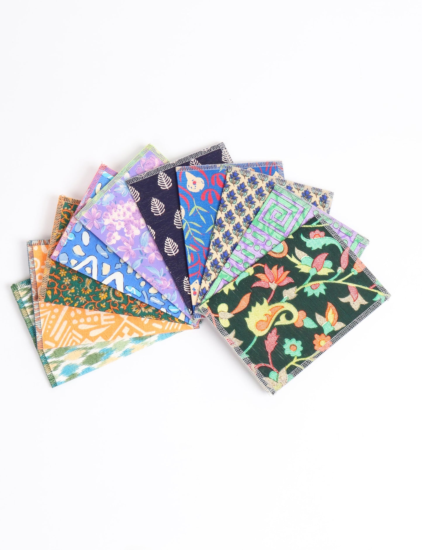 Sustainably crafted FOLDED POSTCARD SET, 10 assorted pieces made with 100% recycled paper and printed sari fabric sourced from Mumbai markets. Eco-friendly with contrast overlock edging. Envelopes included for eco-conscious gratitude and cheerful messages to loved ones.