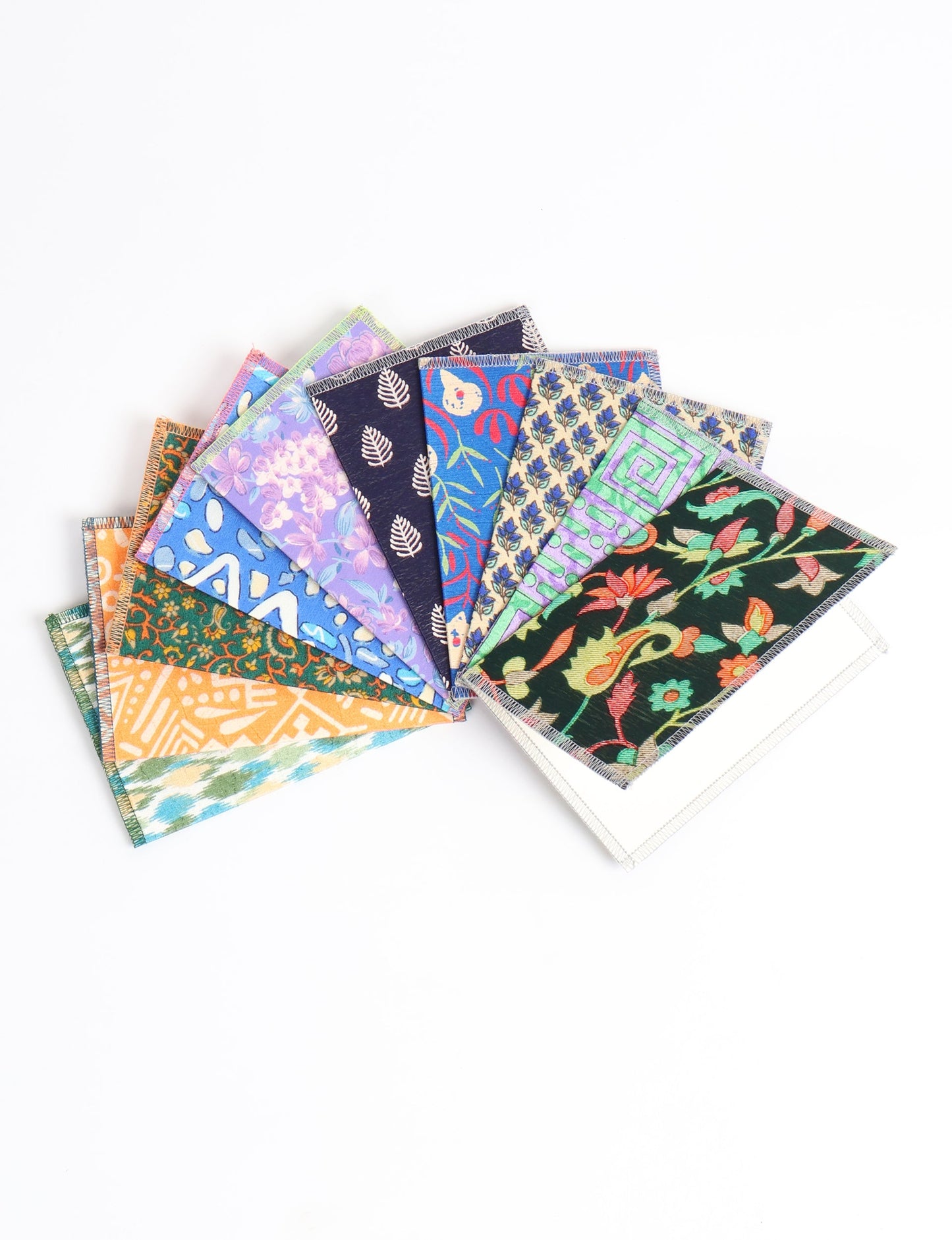 Sustainably crafted FOLDED POSTCARD SET, 10 assorted pieces made with 100% recycled paper and printed sari fabric sourced from Mumbai markets. Eco-friendly with contrast overlock edging. Envelopes included for eco-conscious gratitude and cheerful messages to loved ones.