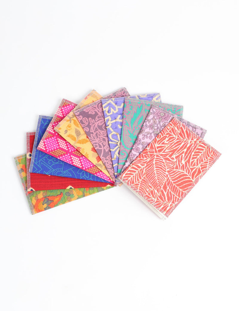 Set of 10 folded postcards with colorful, patterned fabric covers in various floral and geometric designs, fanned out on