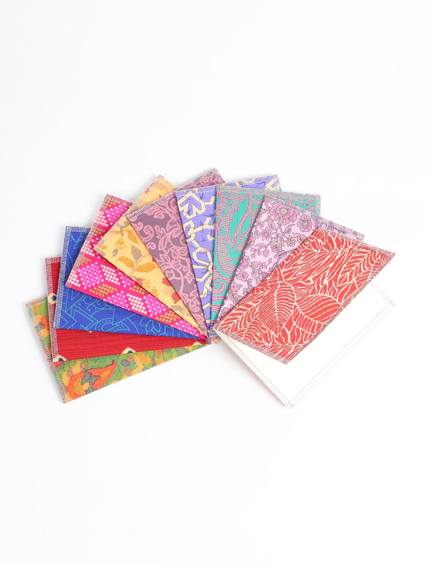 Sustainably crafted FOLDED POSTCARD SET, 10 assorted pieces made with 100% recycled paper and printed sari fabric sourced from Mumbai markets. Eco-friendly with contrast overlock edging. Envelopes included for eco-conscious gratitude and cheerful messages to loved ones.