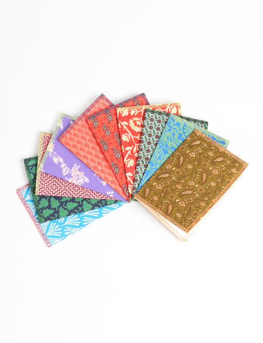 Sustainably crafted FOLDED POSTCARD SET, 10 assorted pieces made with 100% recycled paper and printed sari fabric sourced from Mumbai markets. Eco-friendly with contrast overlock edging. Envelopes included for eco-conscious gratitude and cheerful messages to loved ones.