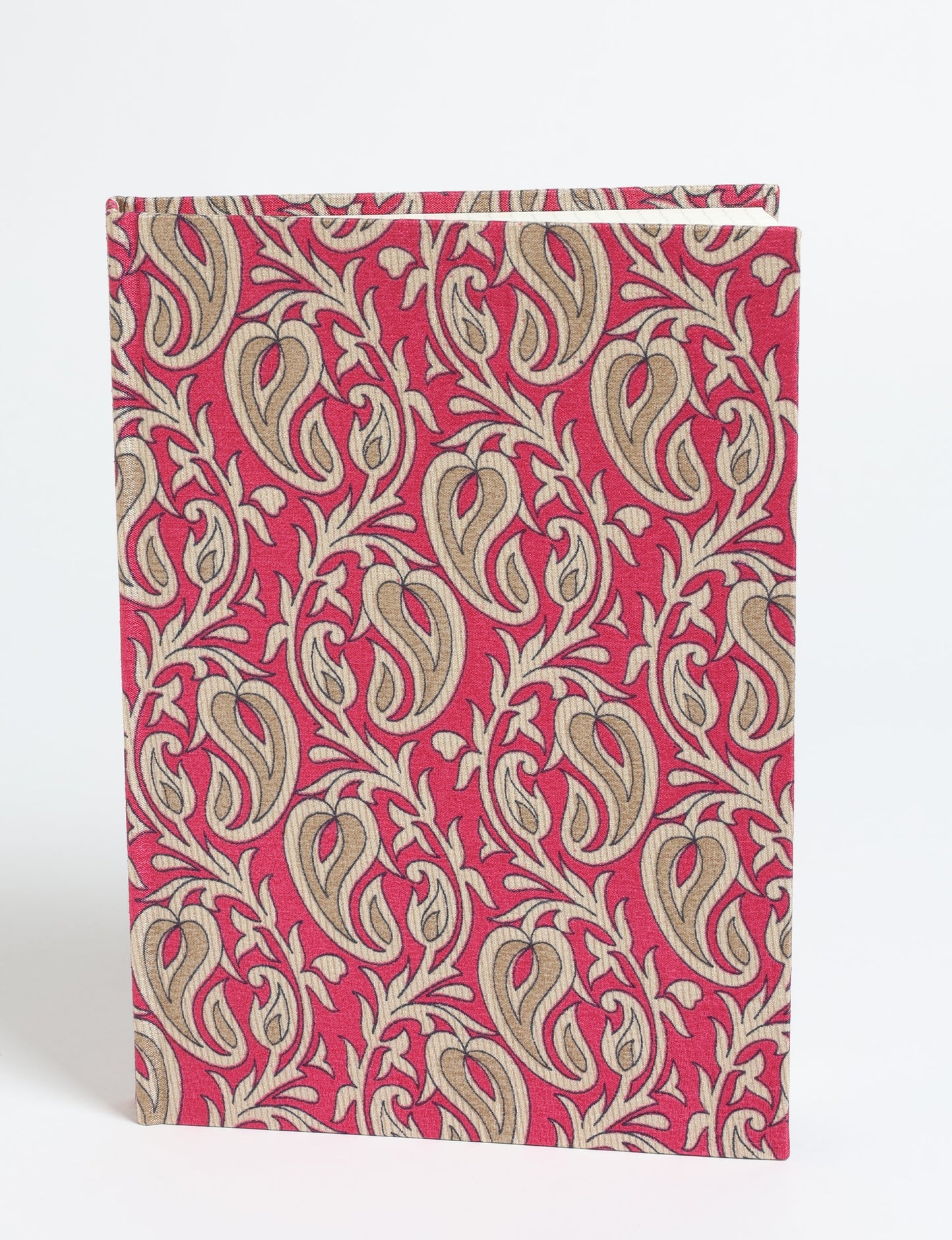 A5 hard cover notebook with pink paisley pattern and beige leaf designs, shown standing upright on white background