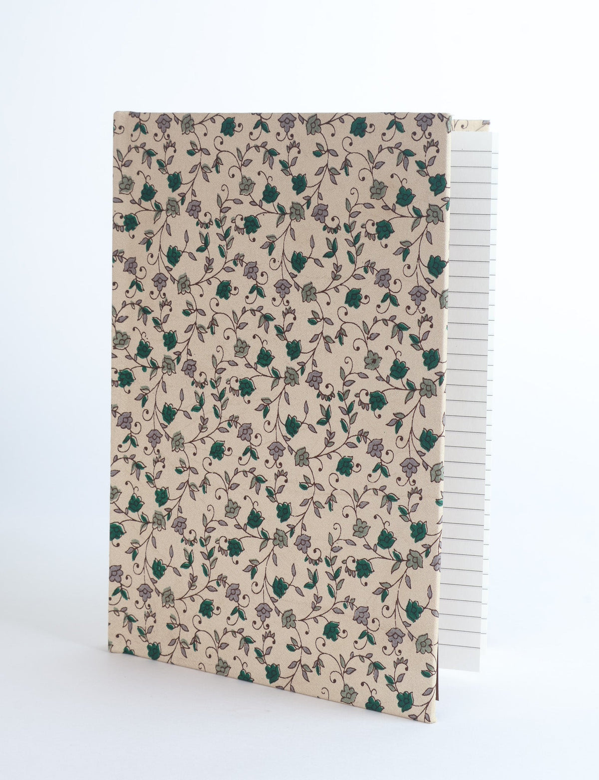 Beige A5 hard cover notebook with green and gray floral vine pattern, shown partially open with lined pages visible