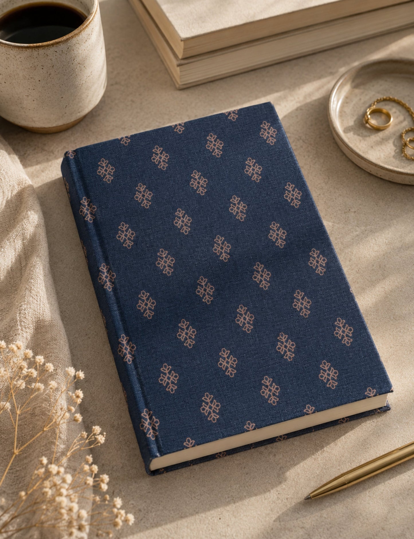 A5 hard cover notebook with green cover and beige floral pattern, shown closed on a wooden surface
