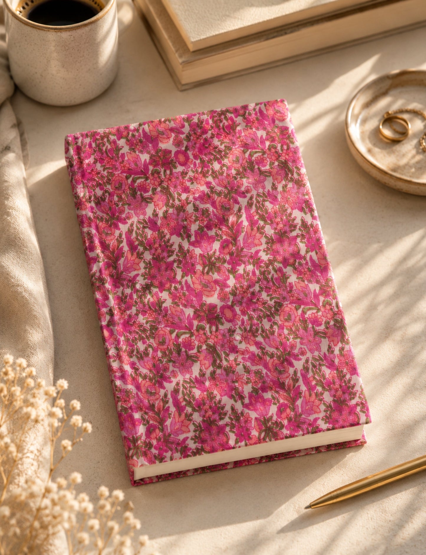 A5 hard cover notebook with green cover and beige floral pattern, shown closed on a wooden surface