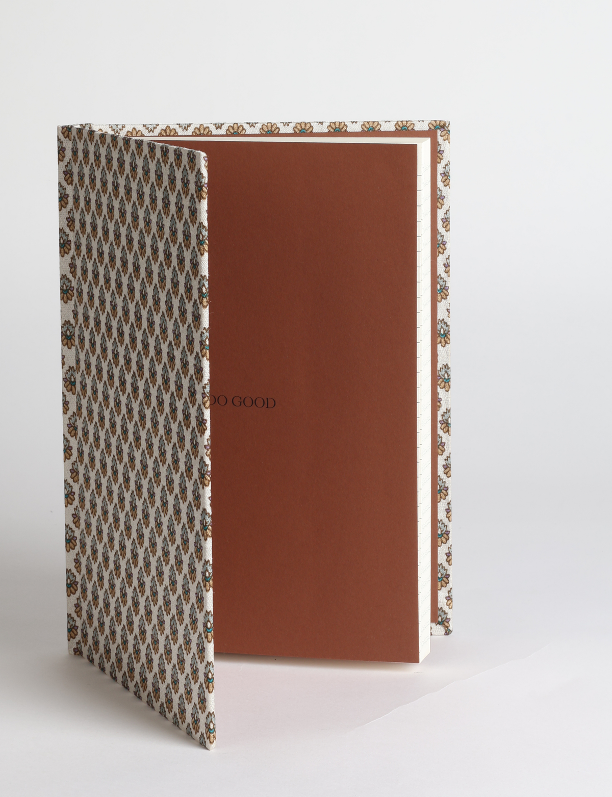 A5 hard cover notebook featuring the DO GOOD message, durable hardbound cover, ruled inner pages, printed endpapers and a lay-flat design.