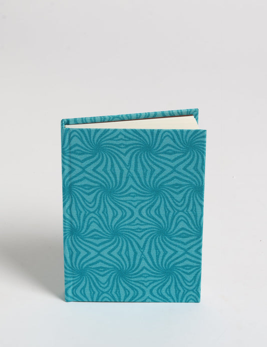 Indulge your creative spirit with our A6 hardcover notebook – a blend of sustainability and style. Made with 100% recycled paper and adorned with pre-loved sari fabric, this eco-conscious notebook encourages mindful note-taking and resonates with the principles of eco-friendly fashion.