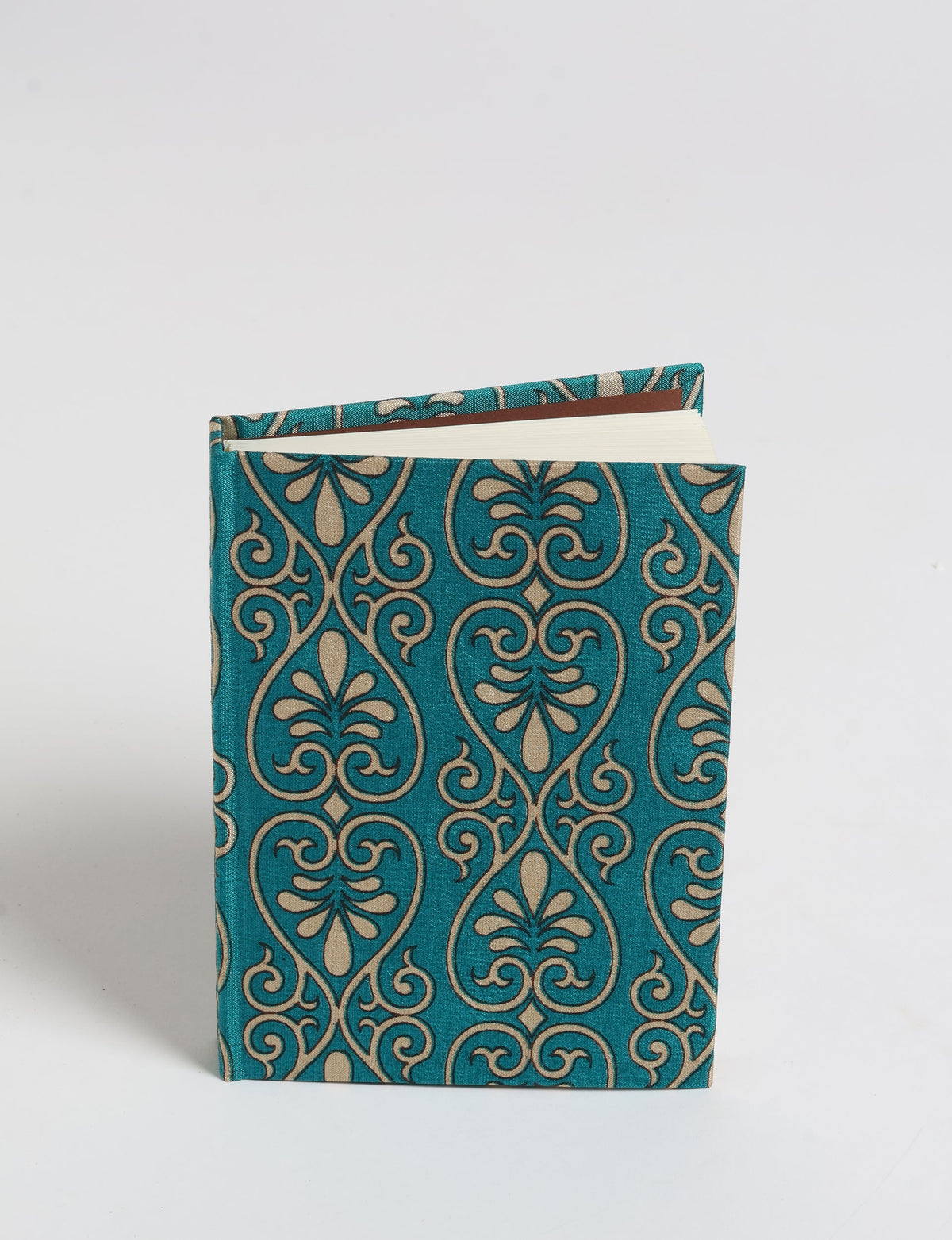A6 hard cover notebook with teal and beige pre-loved sari fabric cover, shown standing with pages slightly open