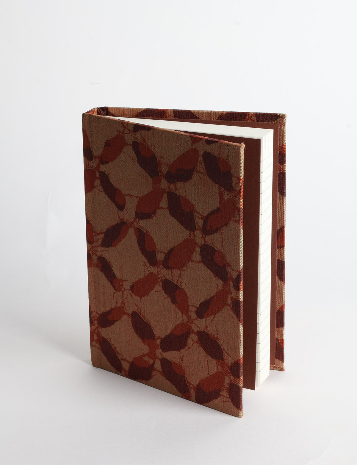 A6 hard cover notebook with teal pre-loved sari fabric cover featuring dark green floral vine pattern, standing upright