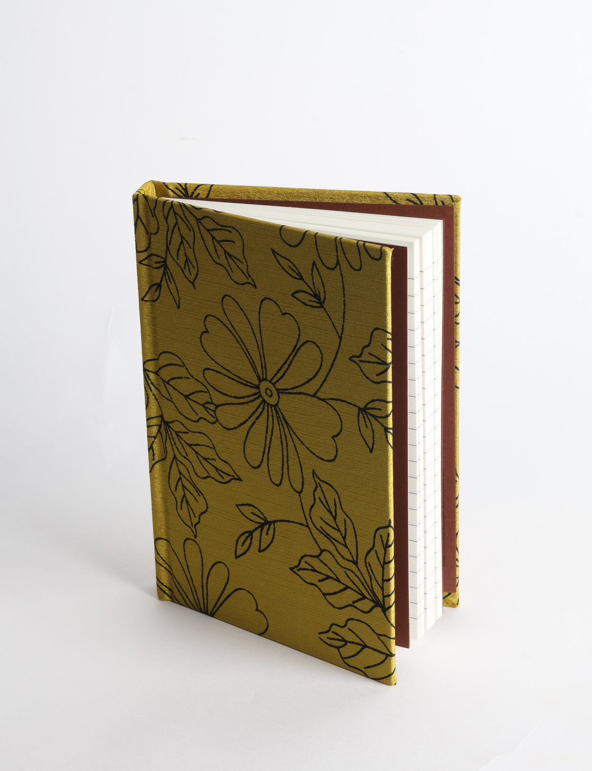 A6 hard cover notebook with teal pre-loved sari fabric cover featuring dark green floral vine pattern, standing upright