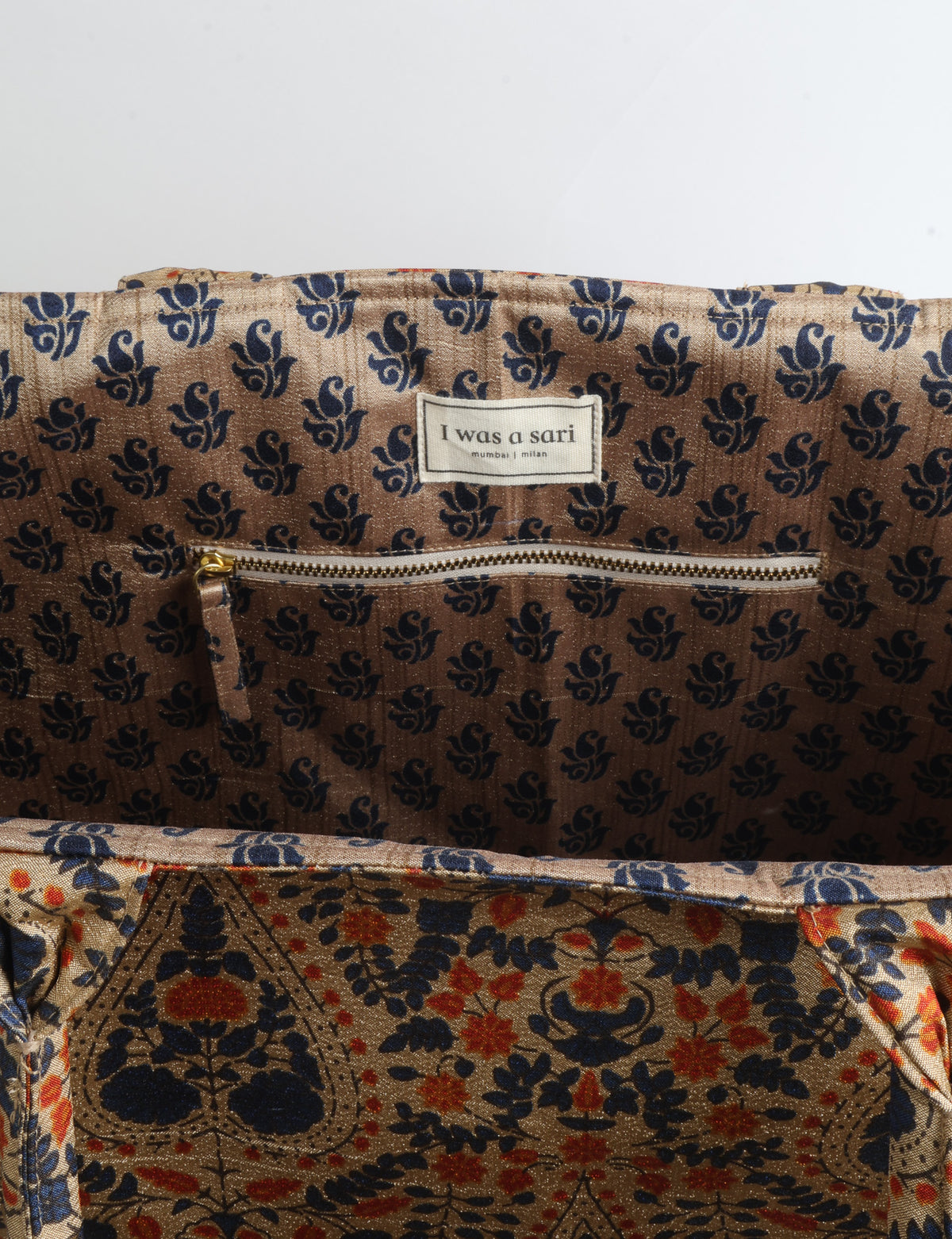 Grey floral fabric work tote bag with blue and beige flowers, teal interior lining with beige polka dots, and fabric handles