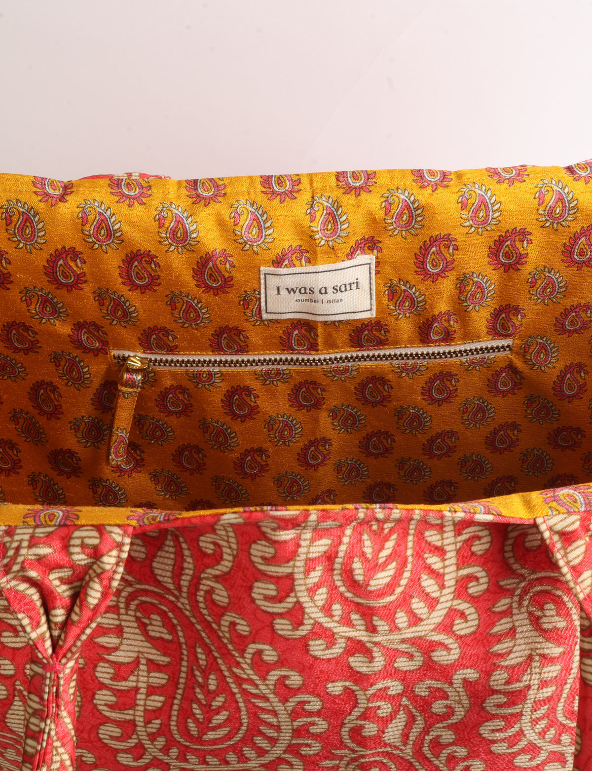 Grey floral fabric work tote bag with blue and beige flowers, teal interior lining with beige polka dots, and fabric handles