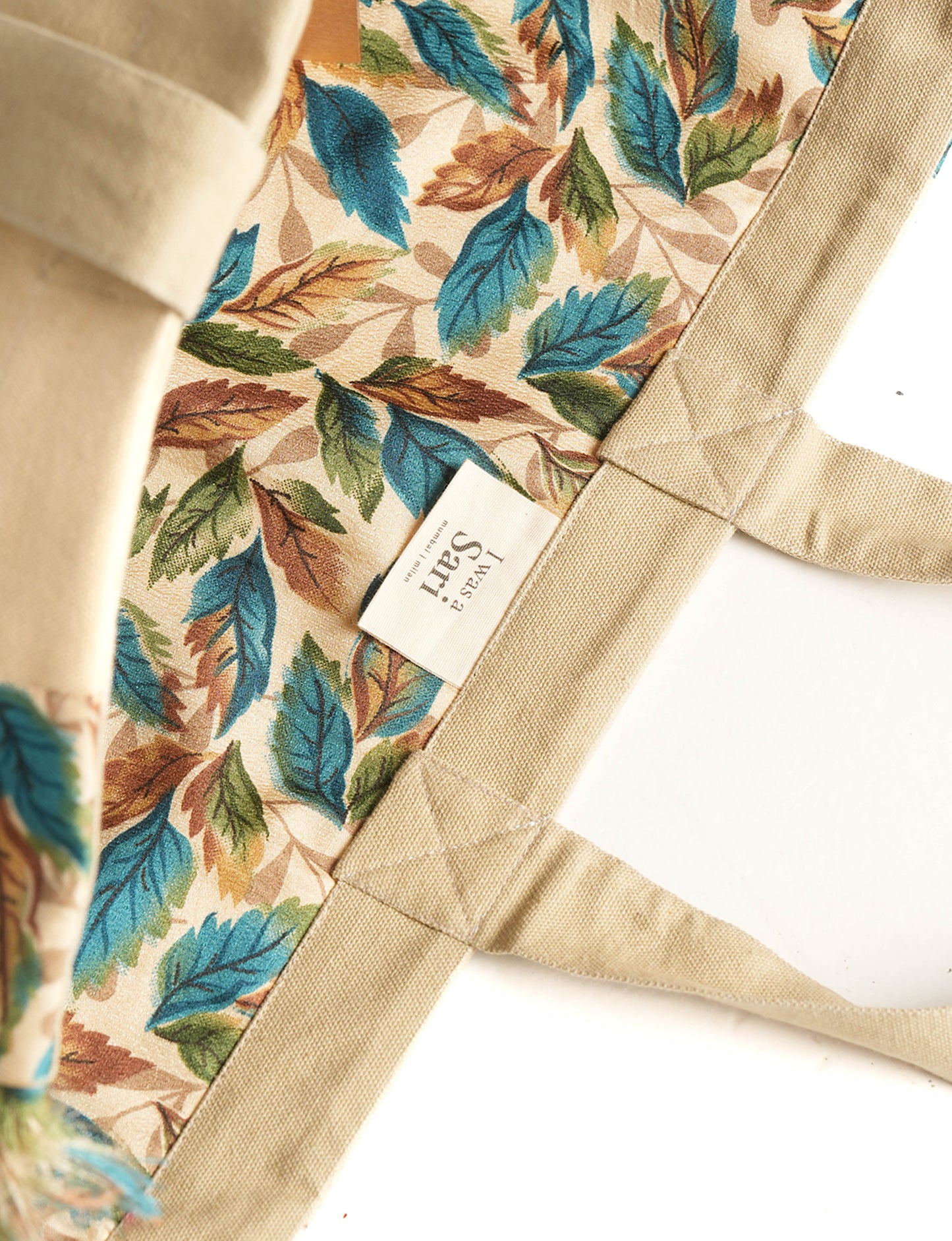 Lighten your eco-load with our FRINGE CARRY-ALL BAG. Soft canvas with a patchwork design, inside lining made of vibrant sari fabric, and beautifully soft sari-fringed edging. Crafted with 100% cotton canvas for a sustainable and stylish carry-all.