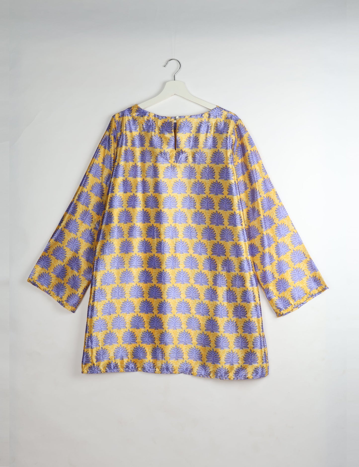 Chic and conscious, our A-line mini swing dress is a must-have in sustainable fashion. Adorned with flared sleeves, a keyhole back opening, and a mother of pearl button with twill tape loop. This zero waste, upcycled garment reflects the essence of eco-friendly and ethical clothing.