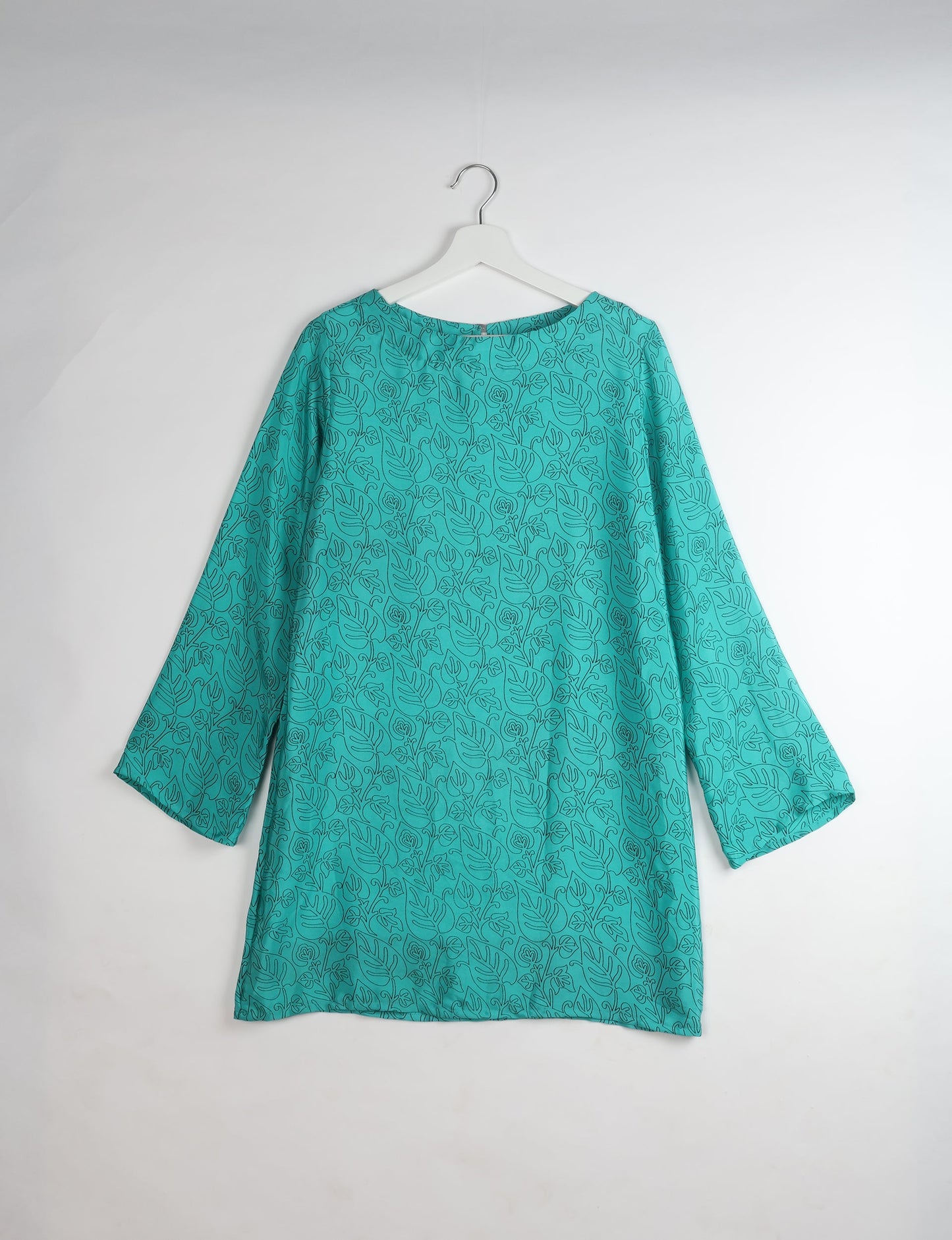 Chic and conscious, our A-line mini swing dress is a must-have in sustainable fashion. Adorned with flared sleeves, a keyhole back opening, and a mother of pearl button with twill tape loop. This zero waste, upcycled garment reflects the essence of eco-friendly and ethical clothing.