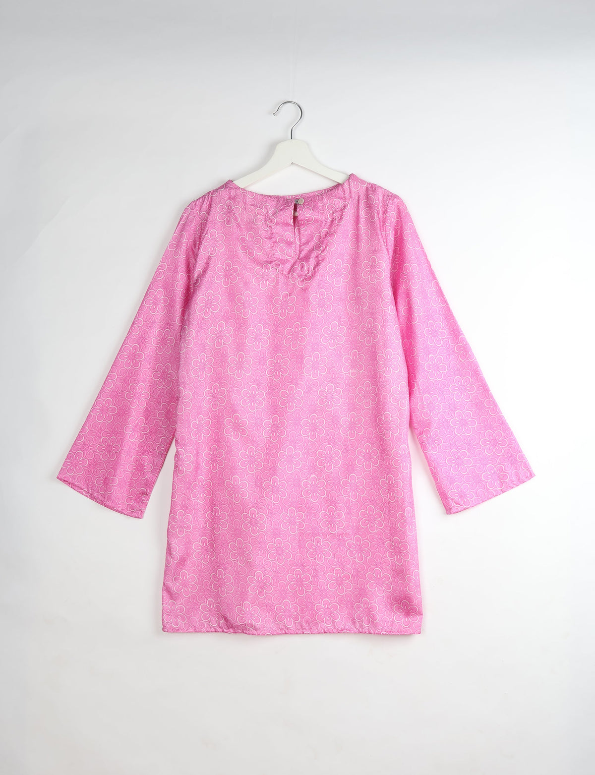 Pink long-sleeve dress with all-over floral pattern, round neckline with back button closure, shown flat on hanger