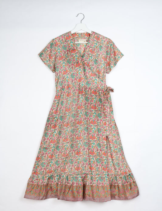 Embrace timeless elegance with our MIDI WRAP DRESS – a midi-length beauty featuring a v-neck, flattery from all angles, and a charming sari belt. Crafted from sustainable materials, this dress embodies ethical clothing and green fashion. Sophisticated with a frill tier at the hem and short cap sleeves, this dress is perfect for any occasion. Tie up the beautifully crafted sari belt on the side for a versatile, stylish, and eco-friendly look.