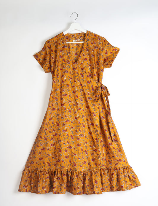 Embrace timeless elegance with our MIDI WRAP DRESS – a midi-length beauty featuring a v-neck, flattery from all angles, and a charming sari belt. Crafted from sustainable materials, this dress embodies ethical clothing and green fashion. Sophisticated with a frill tier at the hem and short cap sleeves, this dress is perfect for any occasion. Tie up the beautifully crafted sari belt on the side for a versatile, stylish, and eco-friendly look.