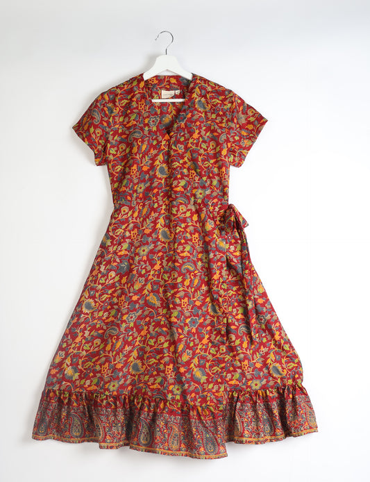 Embrace timeless elegance with our MIDI WRAP DRESS – a midi-length beauty featuring a v-neck, flattery from all angles, and a charming sari belt. Crafted from sustainable materials, this dress embodies ethical clothing and green fashion. Sophisticated with a frill tier at the hem and short cap sleeves, this dress is perfect for any occasion. Tie up the beautifully crafted sari belt on the side for a versatile, stylish, and eco-friendly look.