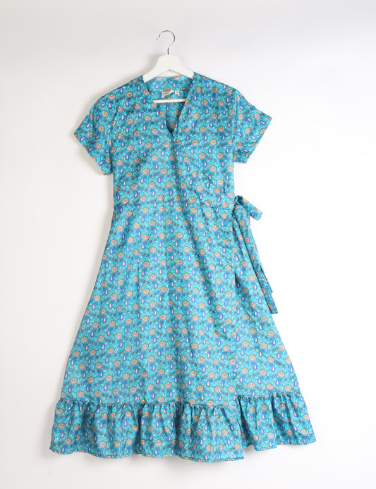 Embrace timeless elegance with our MIDI WRAP DRESS – a midi-length beauty featuring a v-neck, flattery from all angles, and a charming sari belt. Crafted from sustainable materials, this dress embodies ethical clothing and green fashion. Sophisticated with a frill tier at the hem and short cap sleeves, this dress is perfect for any occasion. Tie up the beautifully crafted sari belt on the side for a versatile, stylish, and eco-friendly look.