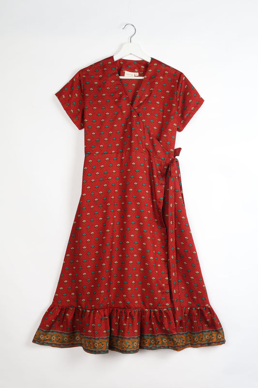 Embrace timeless elegance with our MIDI WRAP DRESS – a midi-length beauty featuring a v-neck, flattery from all angles, and a charming sari belt. Crafted from sustainable materials, this dress embodies ethical clothing and green fashion. Sophisticated with a frill tier at the hem and short cap sleeves, this dress is perfect for any occasion. Tie up the beautifully crafted sari belt on the side for a versatile, stylish, and eco-friendly look.