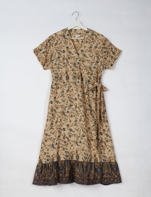 Embrace timeless elegance with our MIDI WRAP DRESS – a midi-length beauty featuring a v-neck, flattery from all angles, and a charming sari belt. Crafted from sustainable materials, this dress embodies ethical clothing and green fashion. Sophisticated with a frill tier at the hem and short cap sleeves, this dress is perfect for any occasion. Tie up the beautifully crafted sari belt on the side for a versatile, stylish, and eco-friendly look.