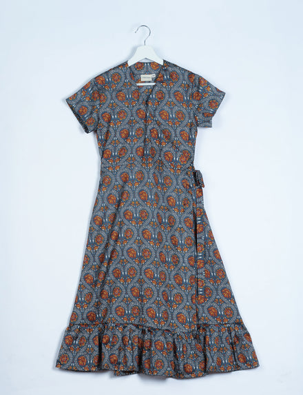 Grey wrap dress with orange floral tropical print, short sleeves, ruffle hem, and side tie belt, shown flat on hanger