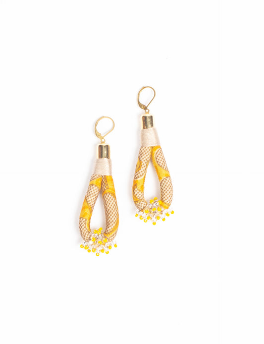 Discover the charm of Beaded Drop Earrings, meticulously crafted by Indian artisans. Recycled cotton rope, sari fabric, and surplus glass beads create an eco-friendly masterpiece. Hypoallergenic metal hooks ensure both style and comfort.