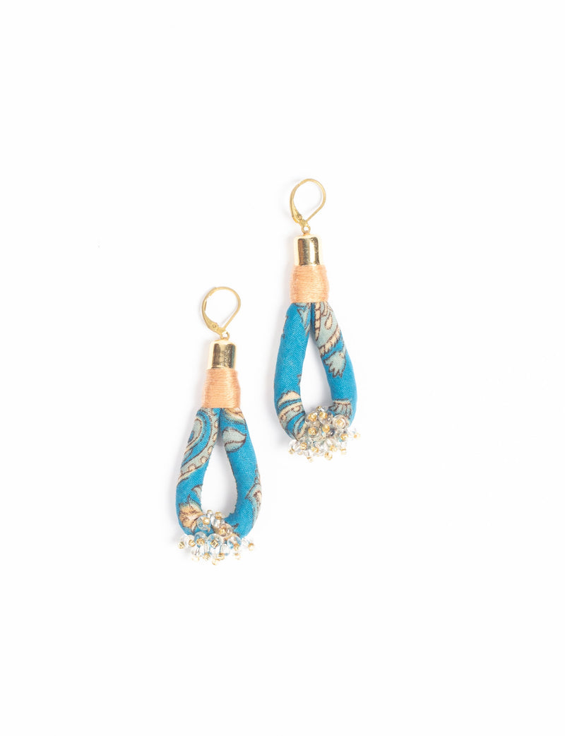 Blue floral fabric loop drop earrings with gold-tone hooks and small clear bead clusters at the bottom