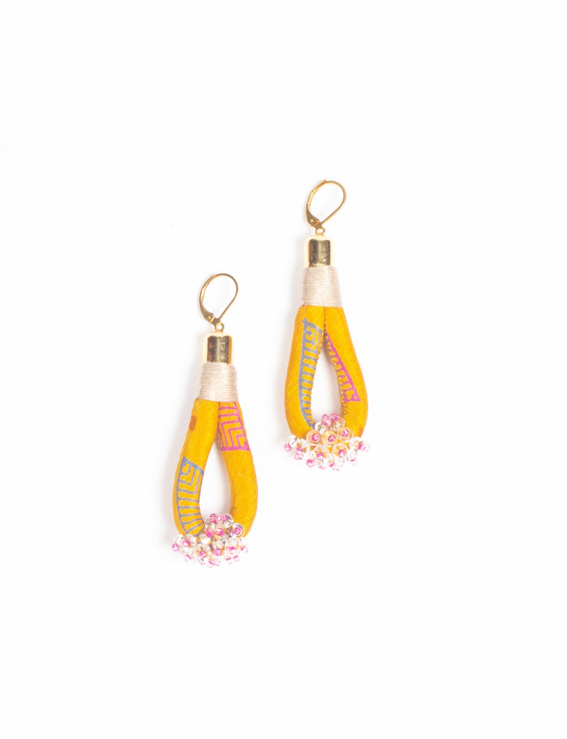 Beaded drop earrings with yellow abstract fabric loops and pink and clear bead clusters at the bottom, shown flat on white background