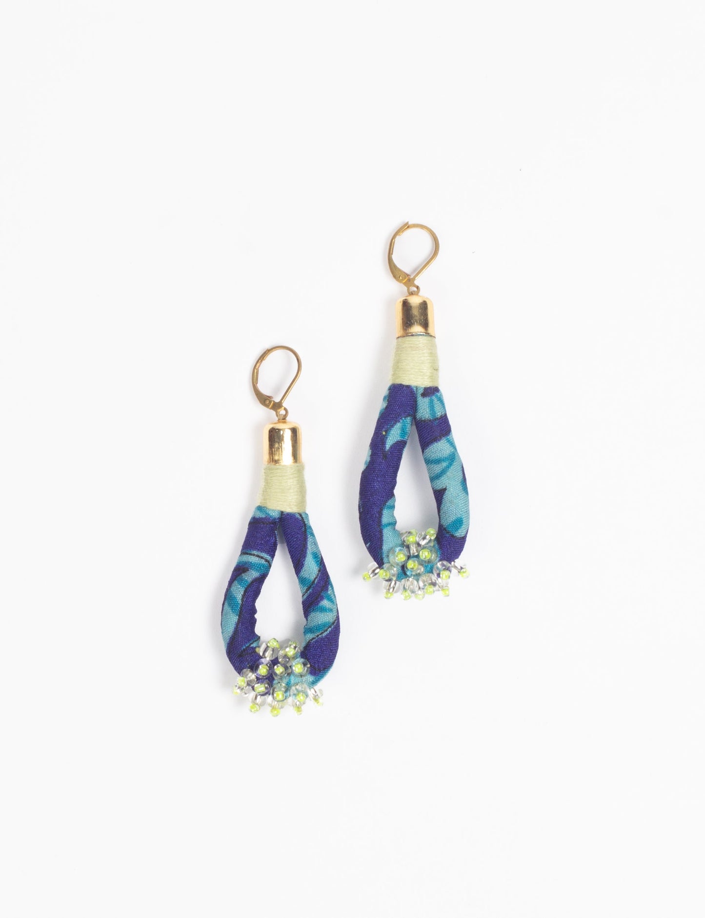 Discover the charm of Beaded Drop Earrings, meticulously crafted by Indian artisans. Recycled cotton rope, sari fabric, and surplus glass beads create an eco-friendly masterpiece. Hypoallergenic metal hooks ensure both style and comfort.