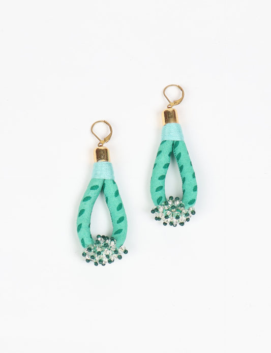 Discover the charm of Beaded Drop Earrings, meticulously crafted by Indian artisans. Recycled cotton rope, sari fabric, and surplus glass beads create an eco-friendly masterpiece. Hypoallergenic metal hooks ensure both style and comfort.