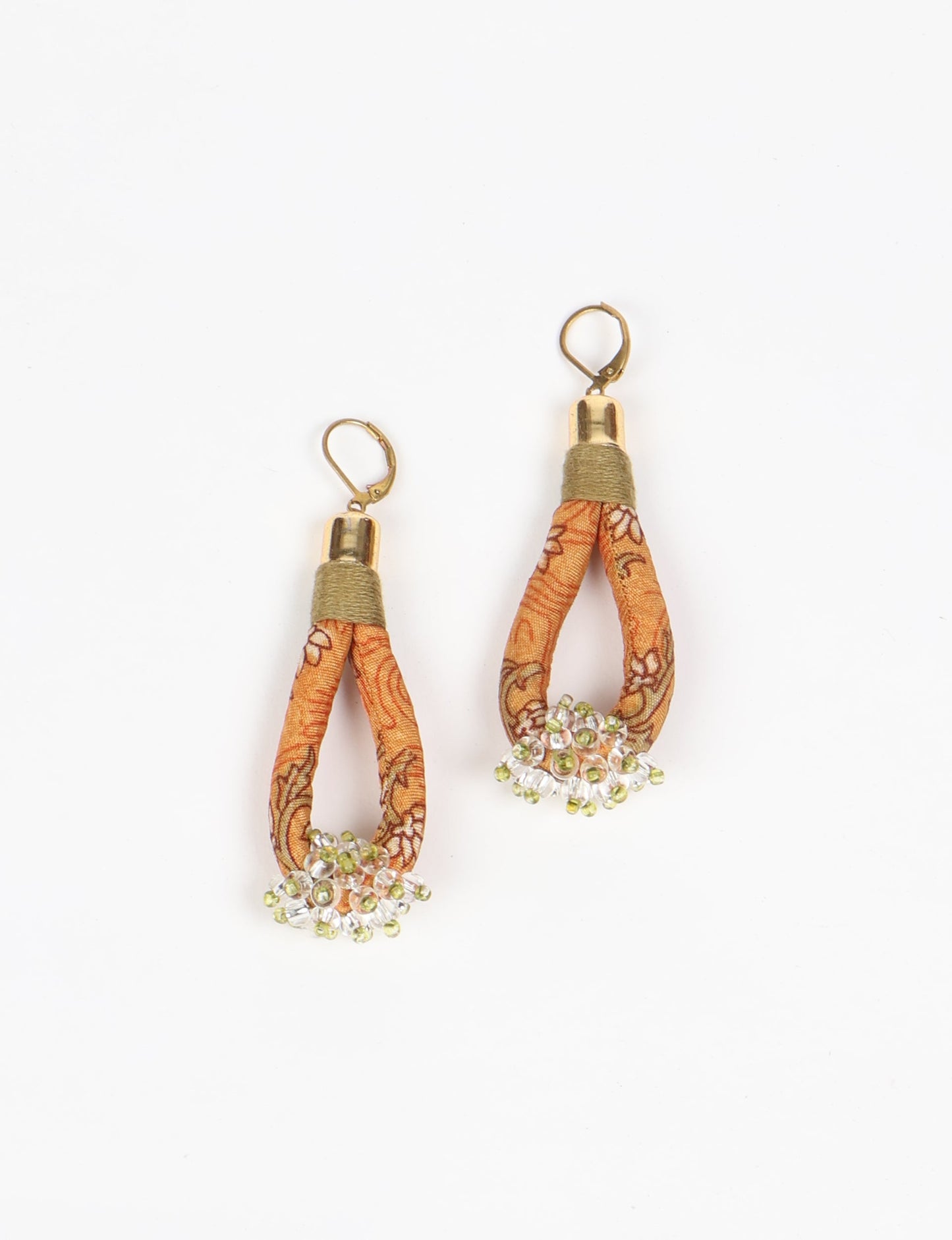 Discover the charm of Beaded Drop Earrings, meticulously crafted by Indian artisans. Recycled cotton rope, sari fabric, and surplus glass beads create an eco-friendly masterpiece. Hypoallergenic metal hooks ensure both style and comfort.