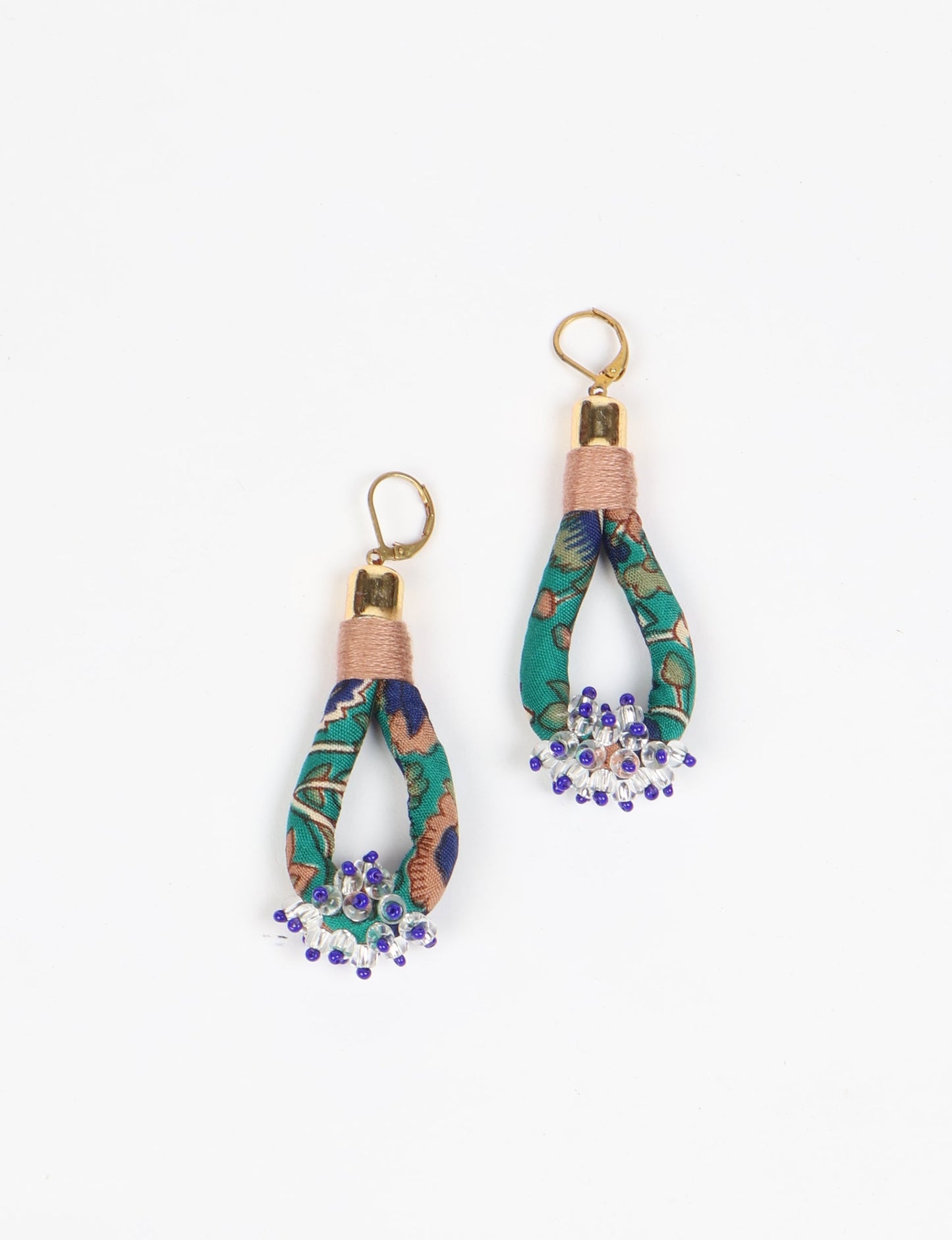 Discover the charm of Beaded Drop Earrings, meticulously crafted by Indian artisans. Recycled cotton rope, sari fabric, and surplus glass beads create an eco-friendly masterpiece. Hypoallergenic metal hooks ensure both style and comfort.