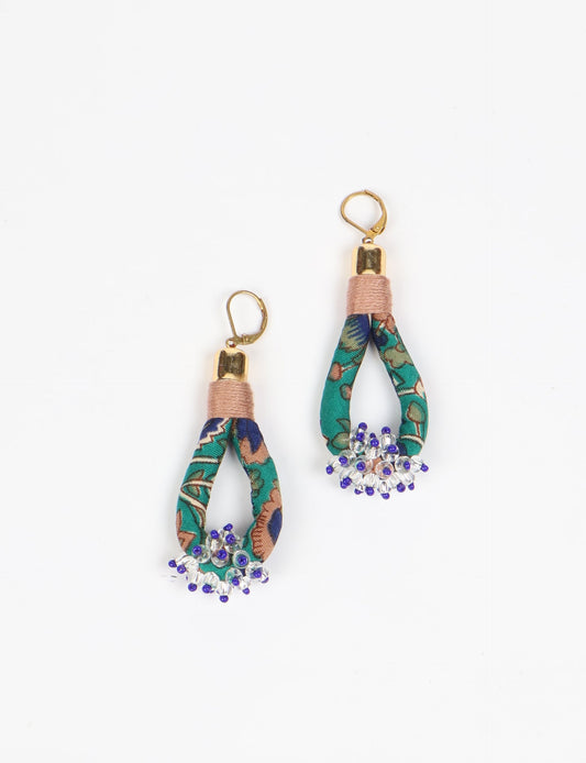 Discover the charm of Beaded Drop Earrings, meticulously crafted by Indian artisans. Recycled cotton rope, sari fabric, and surplus glass beads create an eco-friendly masterpiece. Hypoallergenic metal hooks ensure both style and comfort.